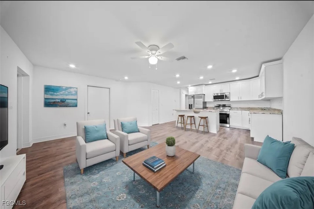 4414 28th Street Southwest Lehigh Acres, FL 33973 - Photo 11 of 29 a living room with furniture and a view of kitchen