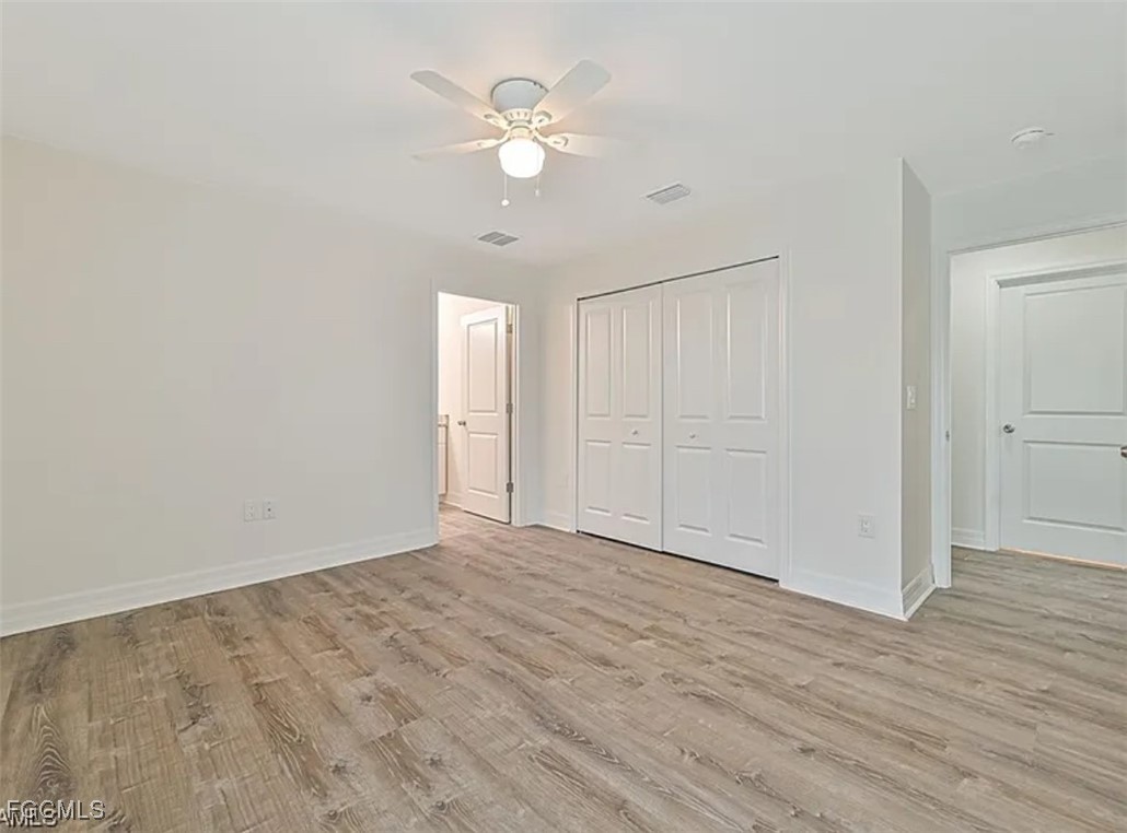 4414 28th Street Southwest Lehigh Acres, FL 33973 - Photo 17 of 29 a view of an empty room with wooden floor