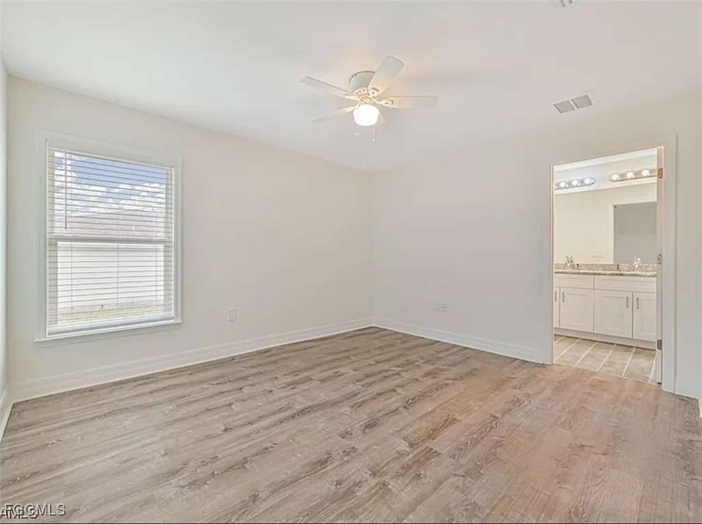 4414 28th Street Southwest Lehigh Acres, FL 33973 - Photo 18 of 29 an empty room with a bathroom and a window