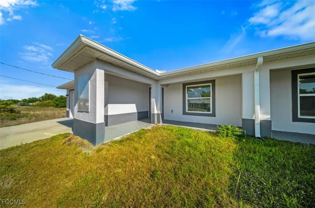 4414 28th Street Southwest Lehigh Acres, FL 33973 - Photo 2 of 29 a view of house with backyard and outdoor seating