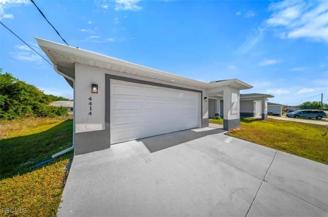 4414 28th Street Southwest Lehigh Acres, FL 33973 - Photo 3 of 29 a front view of a house with a yard