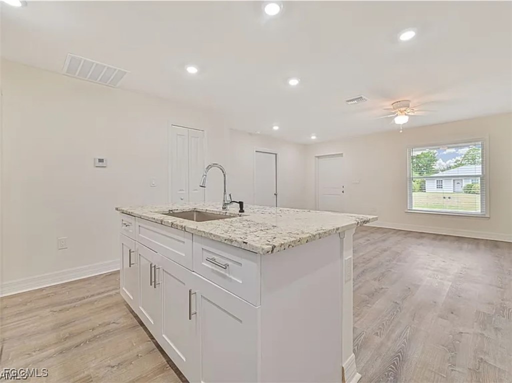4414 28th Street Southwest Lehigh Acres, FL 33973 - Photo 8 of 29 a kitchen with granite countertop a sink and a window