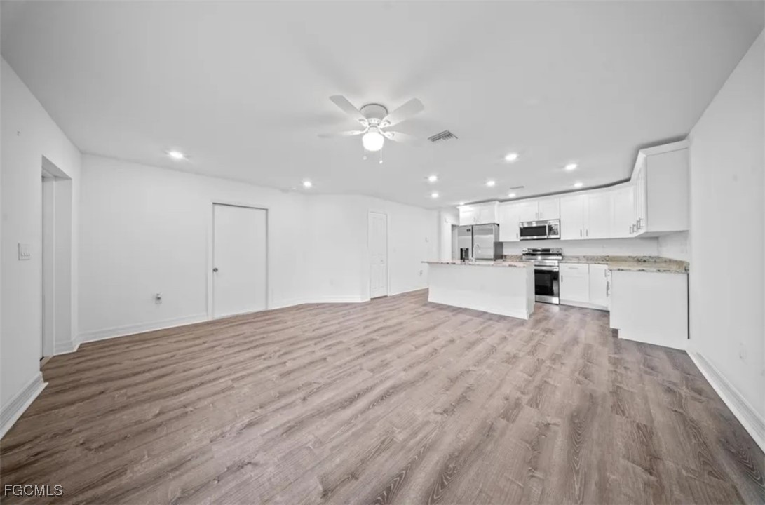 4414 28th Street Southwest Lehigh Acres, FL 33973 - Photo 10 of 29 a view of kitchen with wooden floor and window