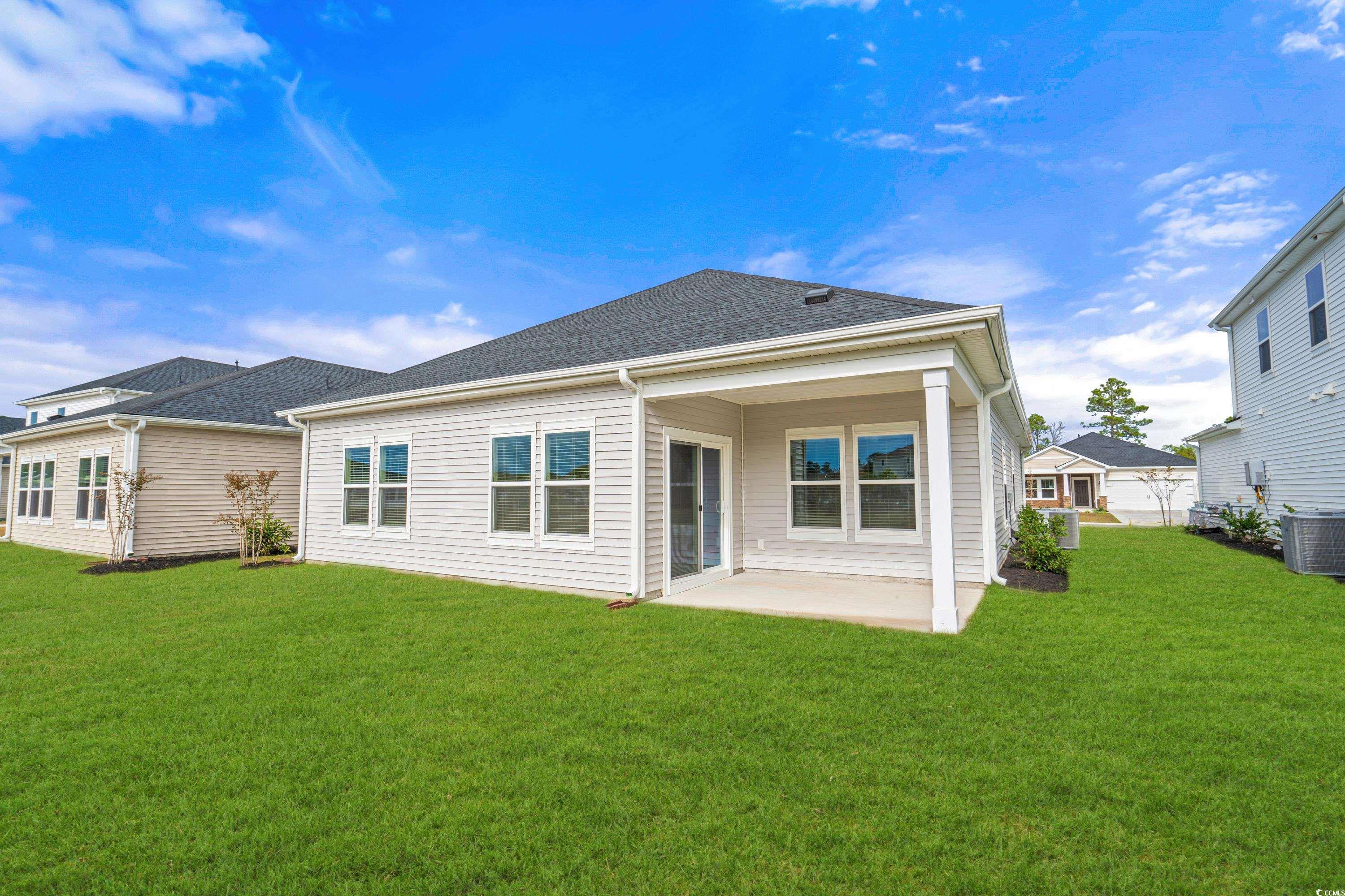8616 Pinnacle Cv Way Longs, SC 29568 - Photo 15 of 32 Rear view of property featuring a lawn, a patio ar