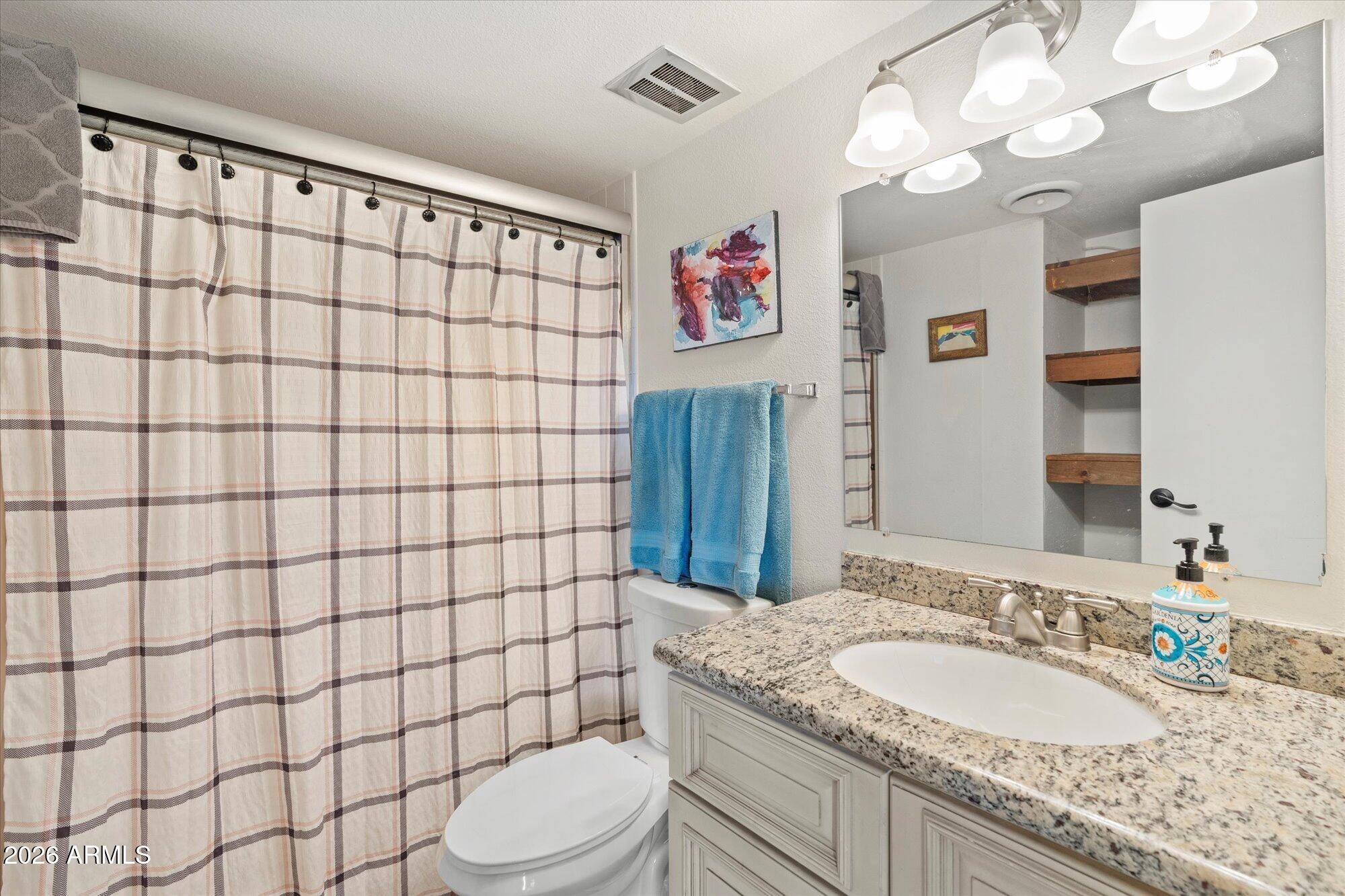 7625 East Camelback Road, Unit B325 Scottsdale, AZ 85251 - Photo 18 of 24 a bathroom with a granite countertop sink a toilet and shower