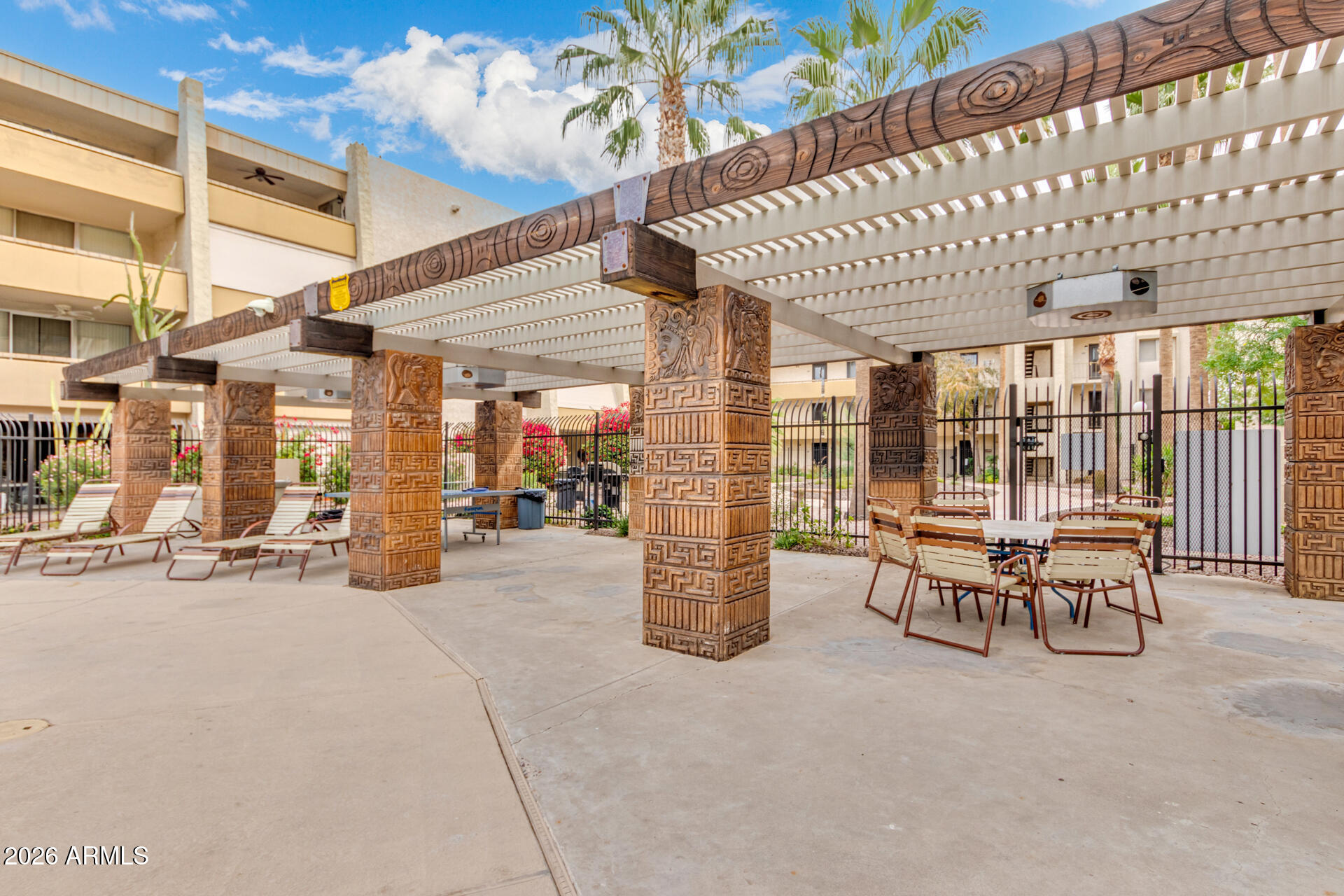 7625 East Camelback Road, Unit B325 Scottsdale, AZ 85251 - Photo 24 of 24 a patio with a table and chairs and potted plants