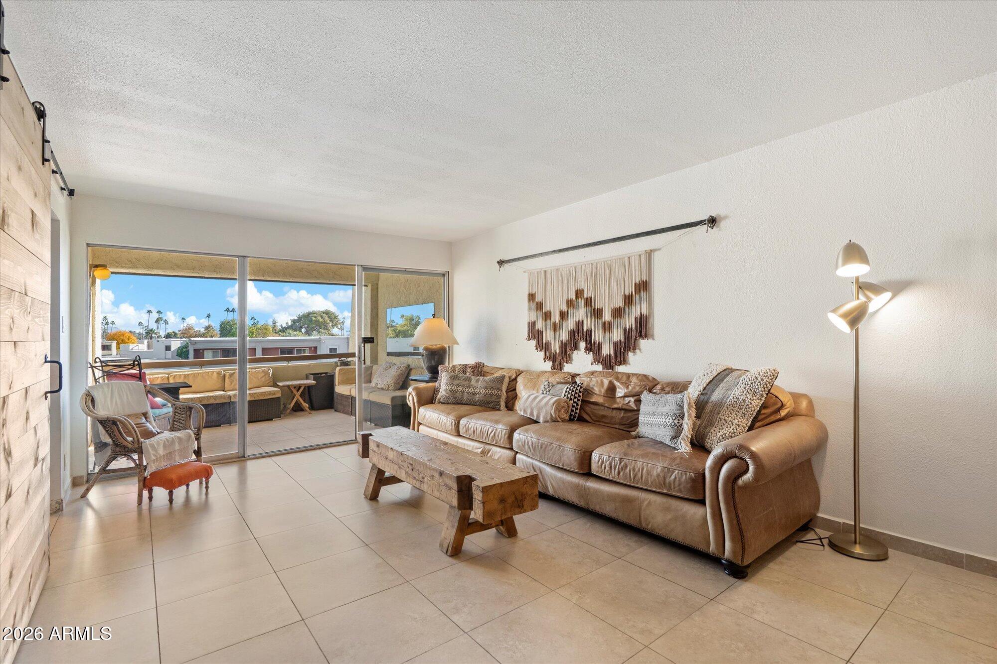 7625 East Camelback Road, Unit B325 Scottsdale, AZ 85251 - Photo 6 of 24 a living room with furniture and a large window