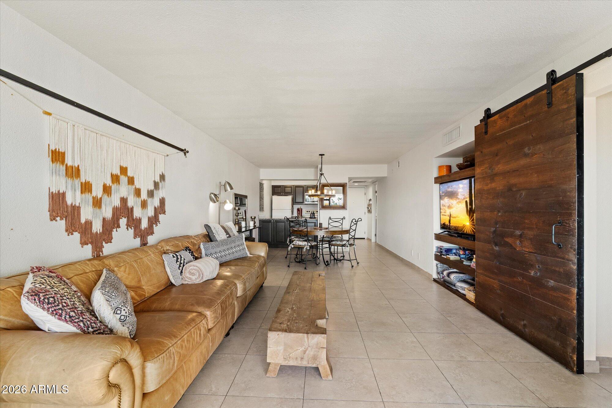 7625 East Camelback Road, Unit B325 Scottsdale, AZ 85251 - Photo 9 of 24 a living room with furniture and a flat screen tv
