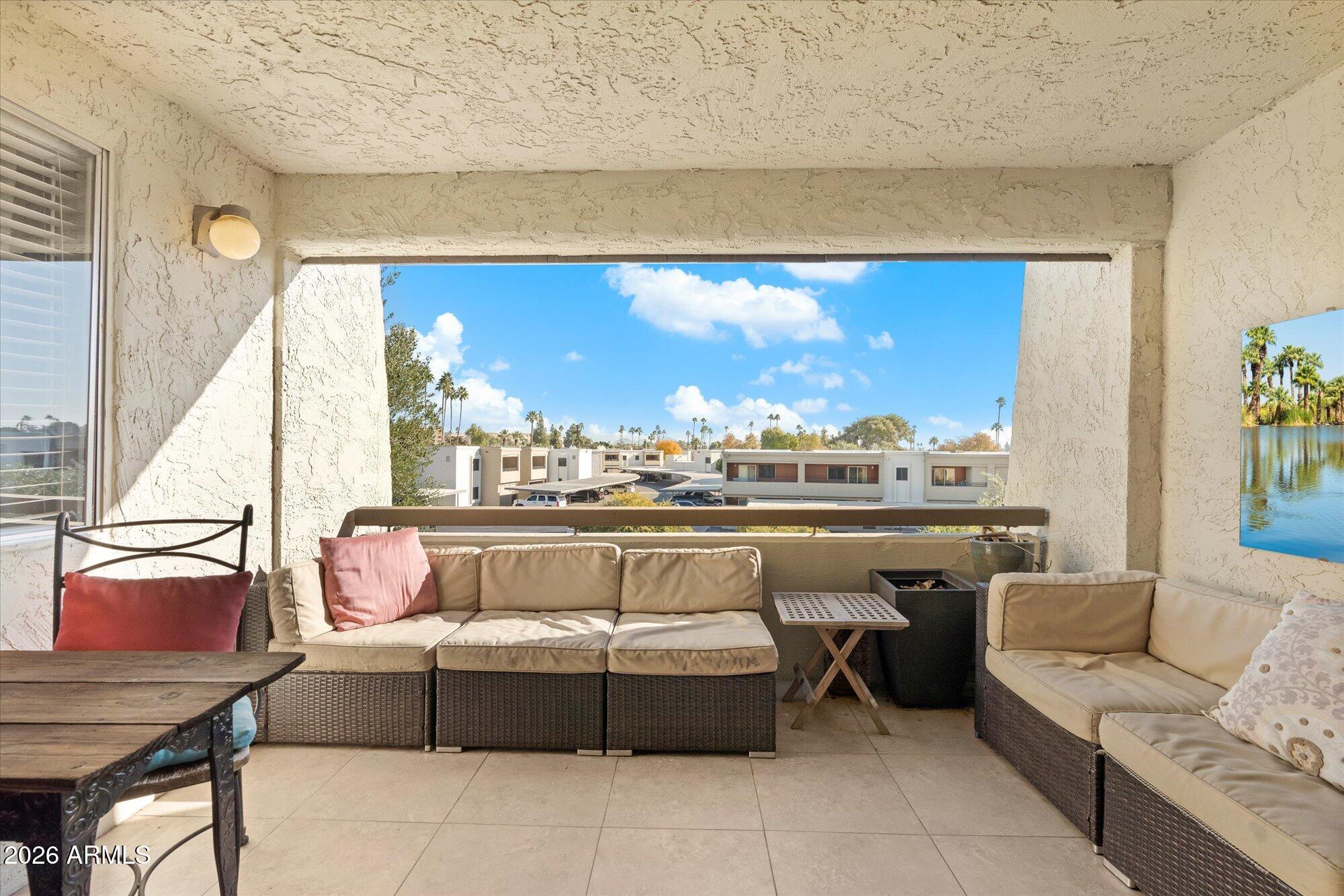 7625 East Camelback Road, Unit B325 Scottsdale, AZ 85251 - Photo 10 of 24 a living room with furniture a window and outdoor view