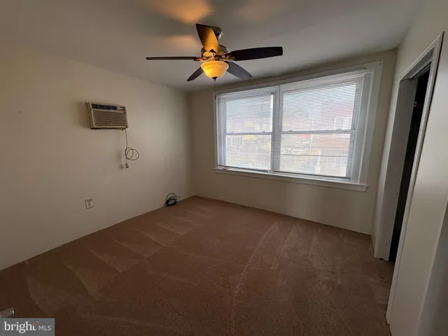 a view of empty room with ceiling fan