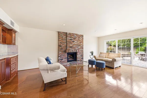 a living room with furniture large window and fireplace