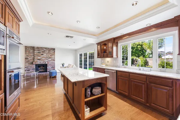 a kitchen with stainless steel appliances granite countertop a stove and a refrigerator