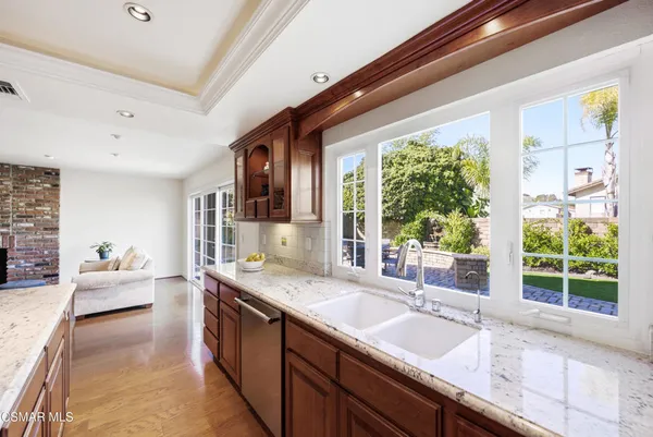 a spacious bathroom with a granite countertop sink and large window
