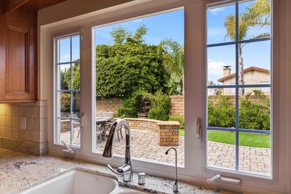 a view of a porch with a floor to ceiling window and wooden fence