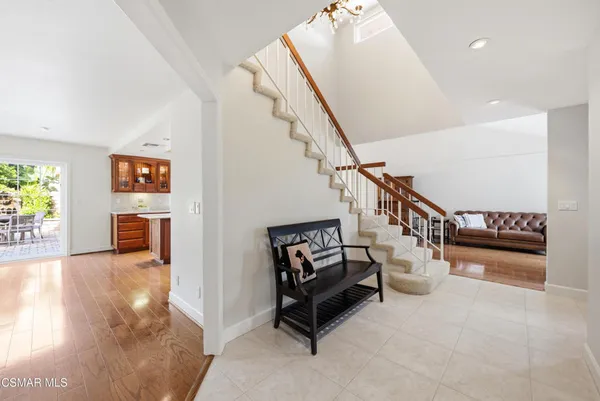 a living room with furniture and stairs