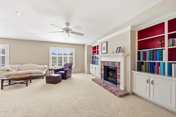 a living room with furniture fireplace and window