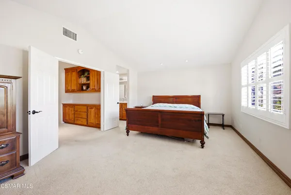 a bedroom with a bed and a cabinets