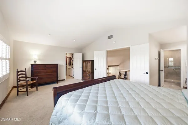 a bedroom with a large bed and a tv