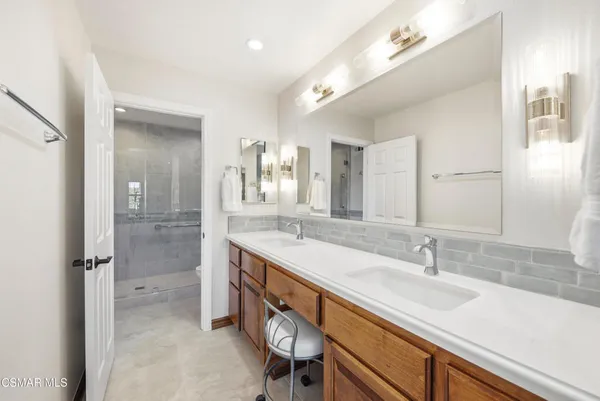 a bathroom with a sink double vanity and a shower