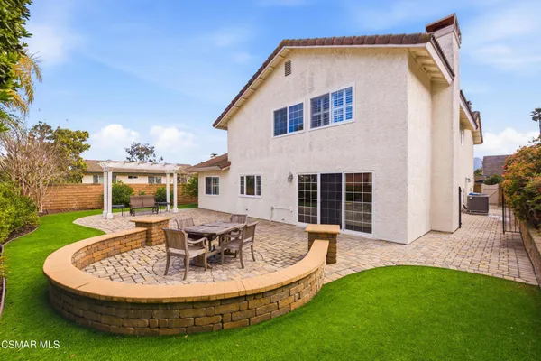a view of a house with backyard tub and fire pit