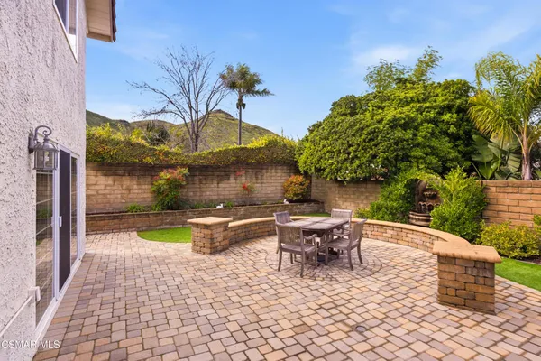 a view of swimming pool with outdoor seating and plants