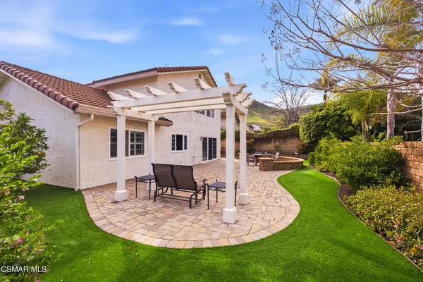 a view of a house with backyard porch and sitting area