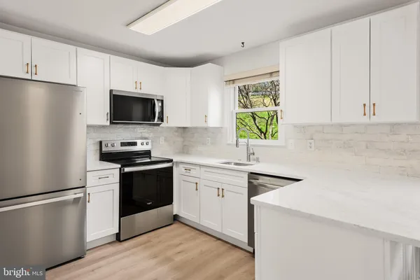 a kitchen with a refrigerator stove and microwave