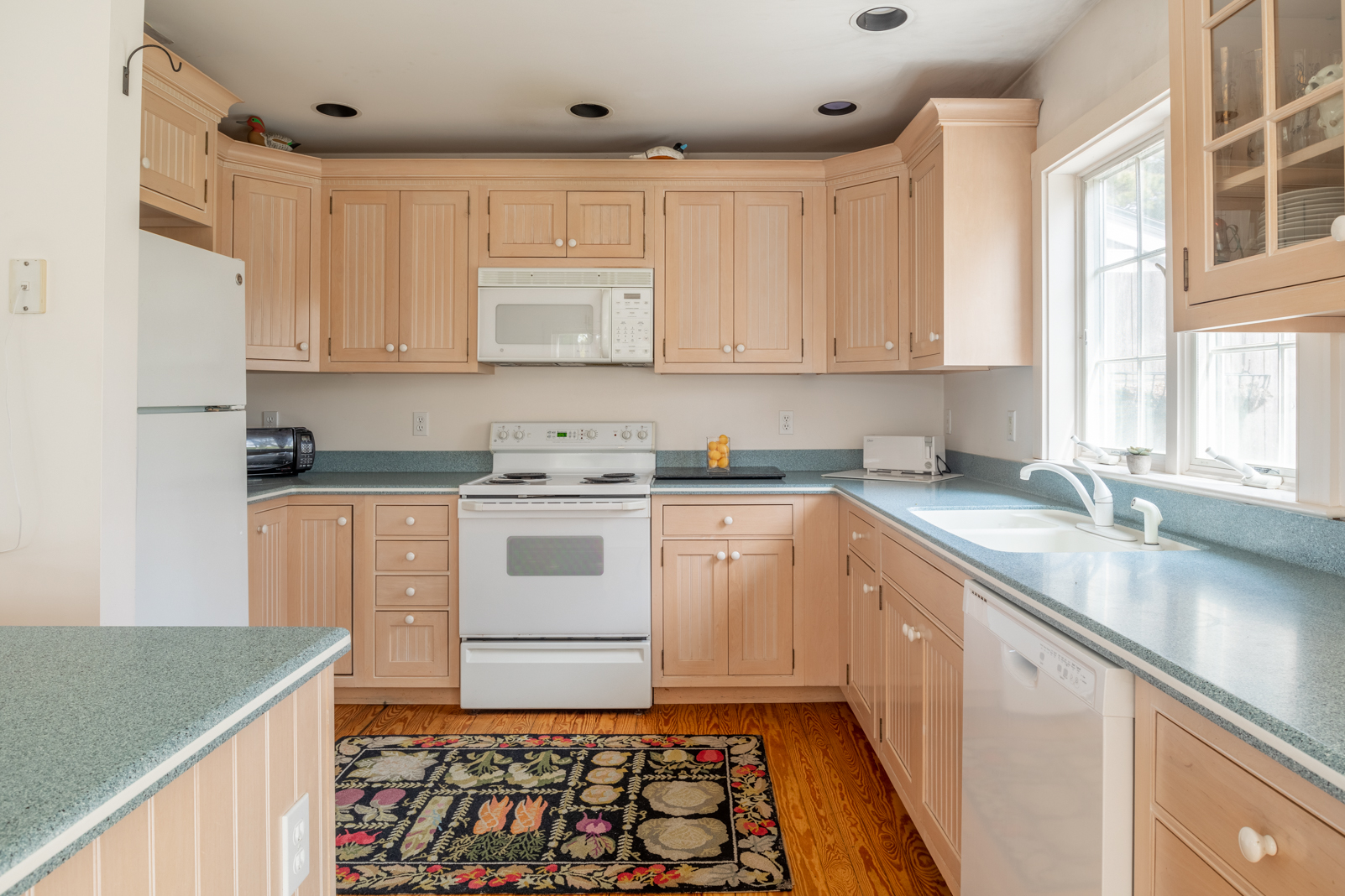 15 Swift Rock Road Nantucket, MA 02554 - Photo 13 of 32 a kitchen with granite countertop white cabinets and white appliances