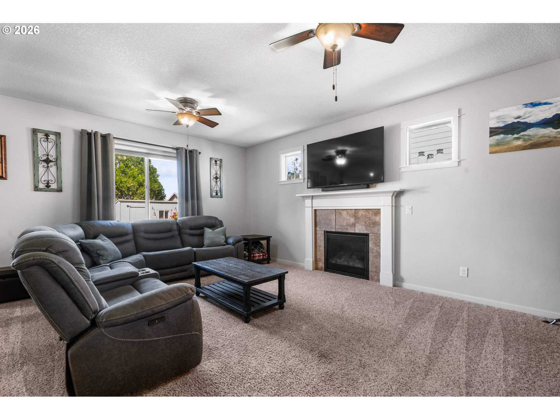 218 Finneys Avenue Molalla, OR 97038 - Photo 5 of 34 a living room with furniture a flat screen tv and a fireplace