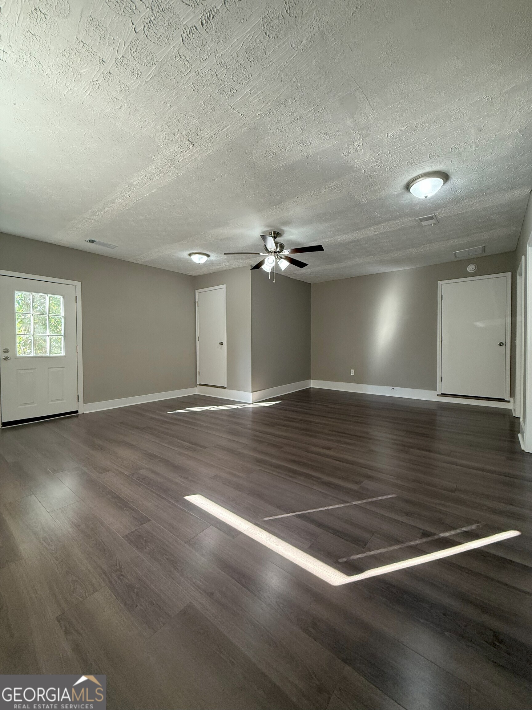 516 Harris Street Monroe, GA 30655 - Photo 11 of 25 a view of empty room with wooden floor