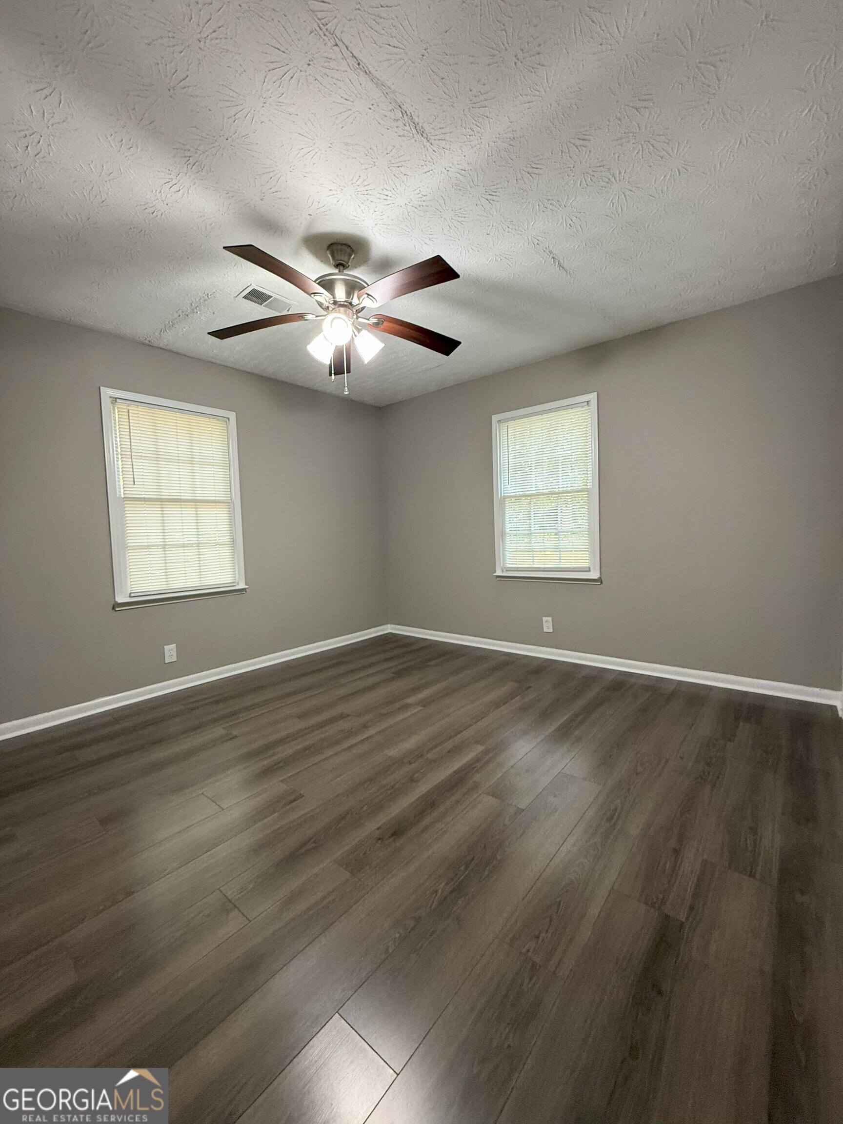 516 Harris Street Monroe, GA 30655 - Photo 15 of 25 wooden floor in an empty room with a window