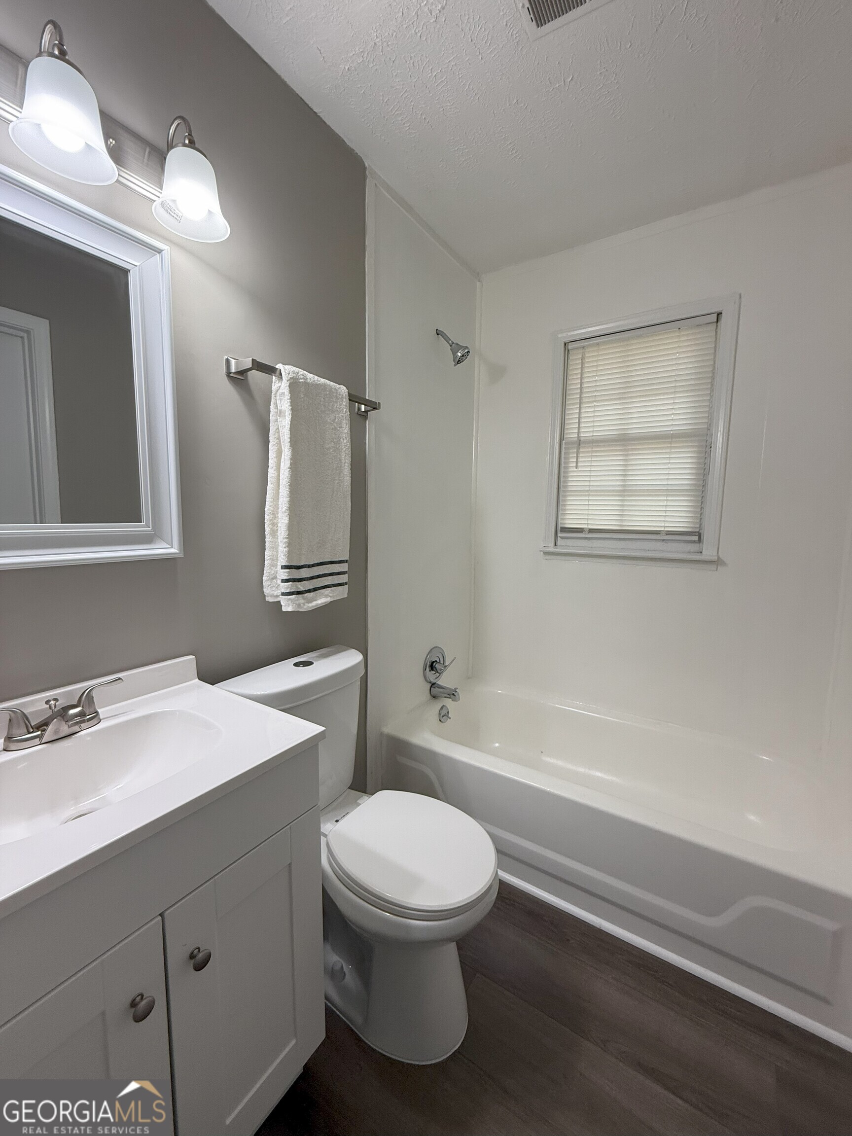 516 Harris Street Monroe, GA 30655 - Photo 17 of 25 a bathroom with a sink a toilet and shower