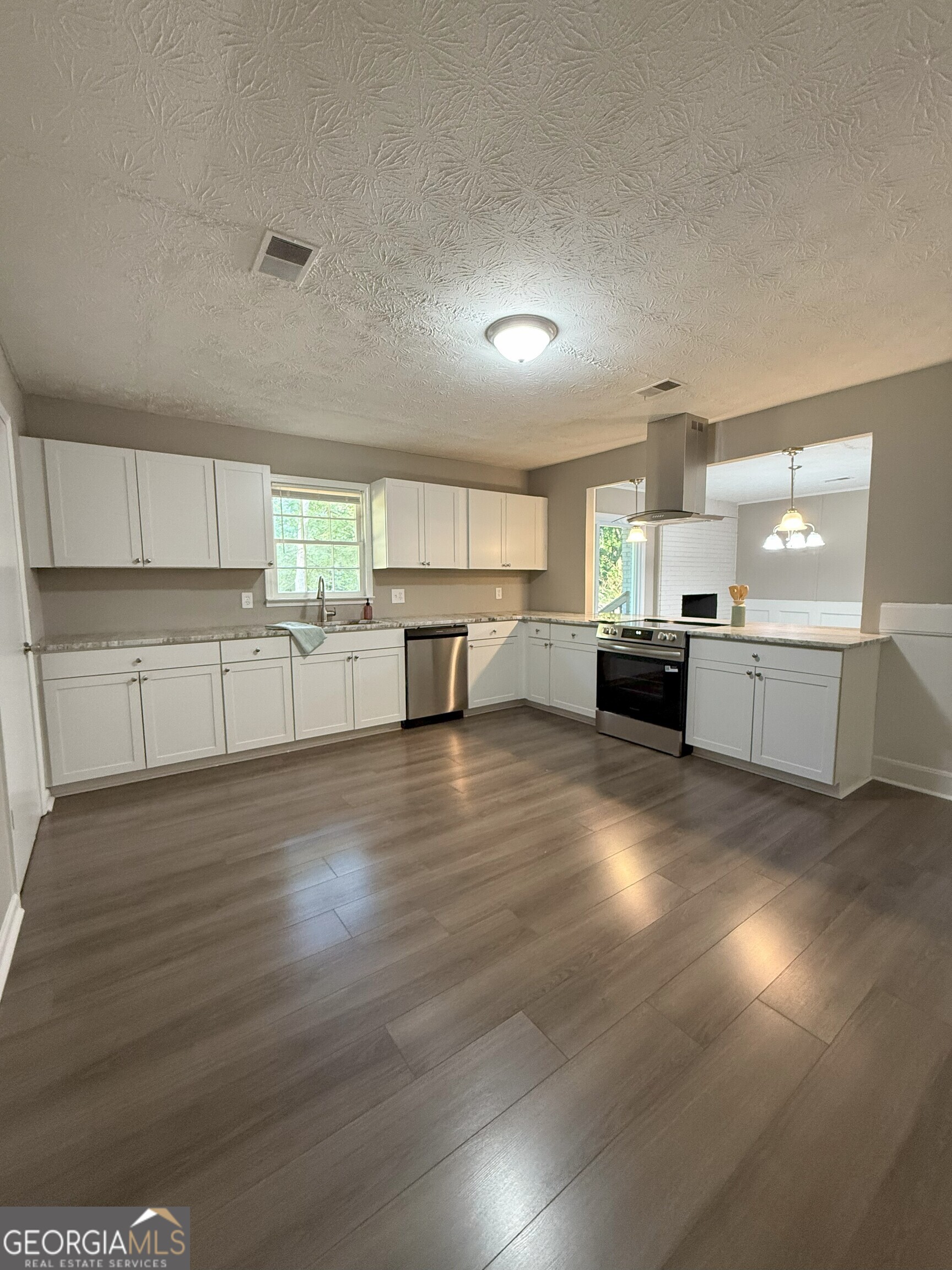 516 Harris Street Monroe, GA 30655 - Photo 2 of 25 a view of kitchen with wooden floor and electronic appliances