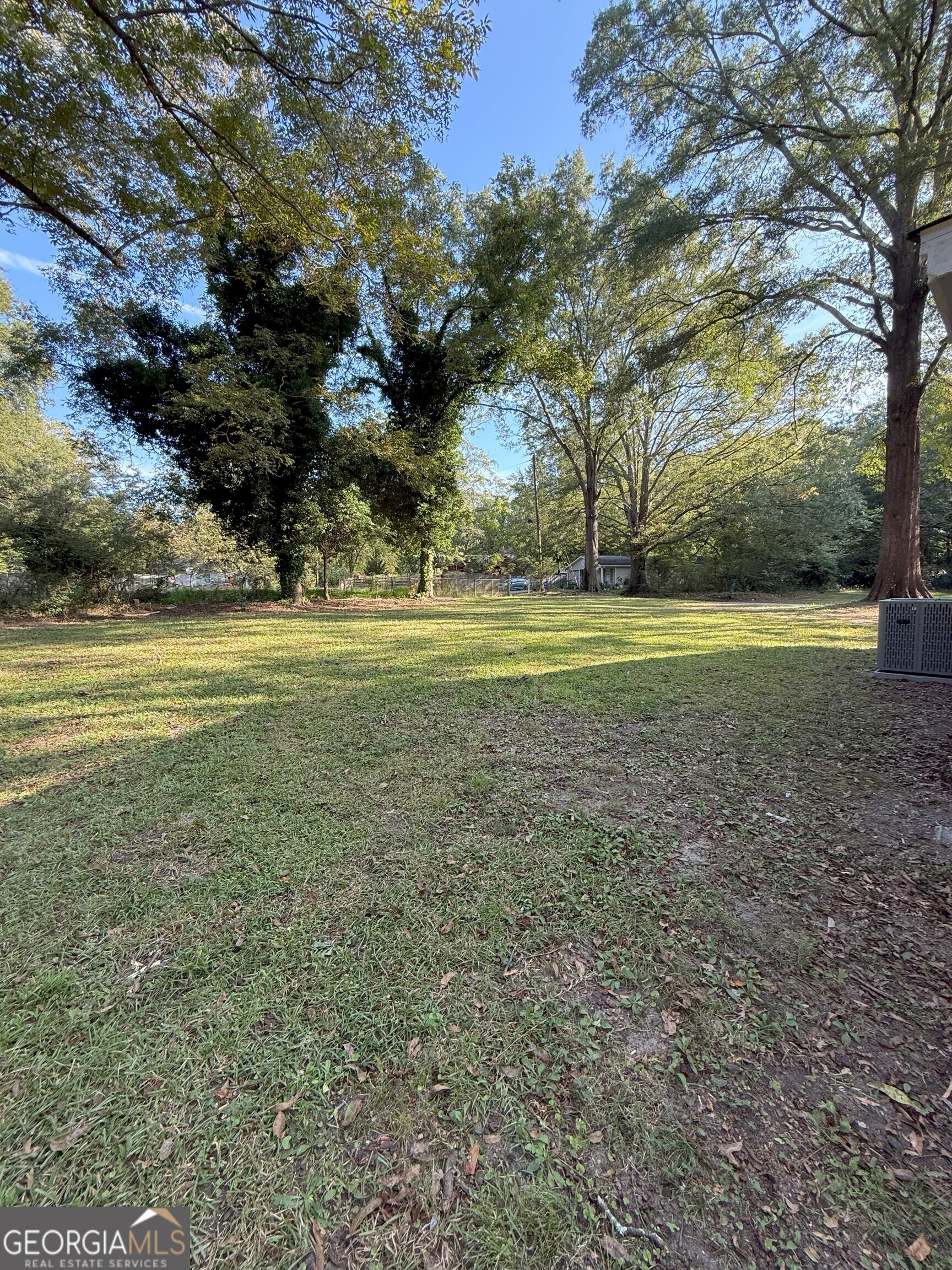 516 Harris Street Monroe, GA 30655 - Photo 22 of 25 a view of a big yard with large trees