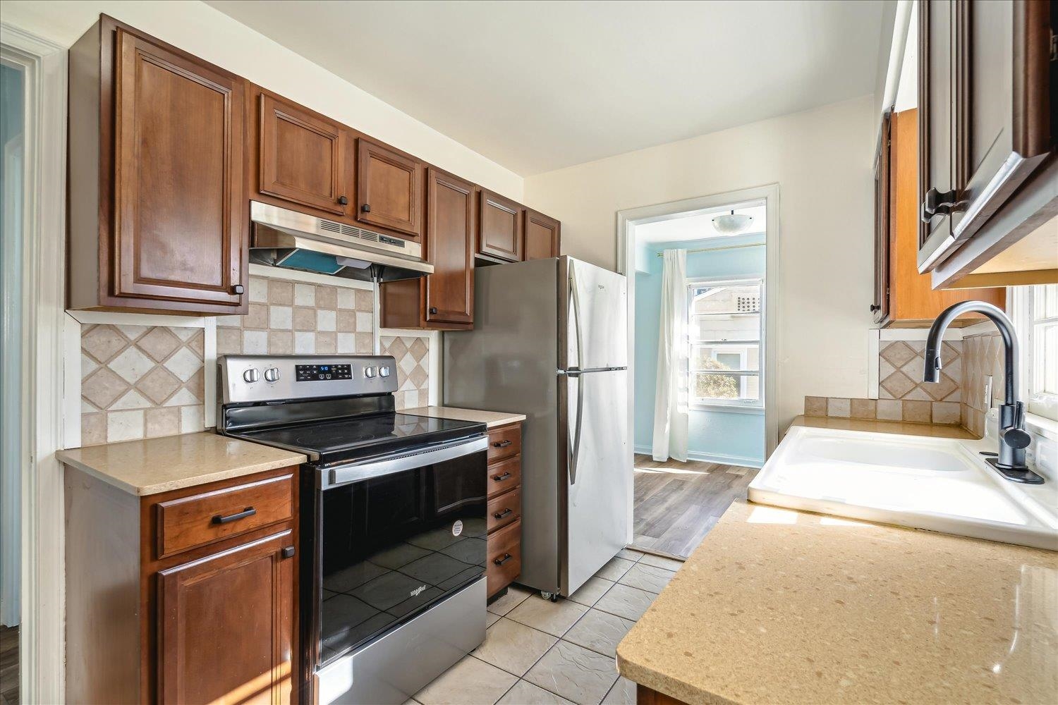 3901 Lytle Circle Memphis, TN 38122 - Photo 13 of 30 Kitchen featuring under cabinet range hood, stainless steel appliances, a wealth of natural light, and a sink
