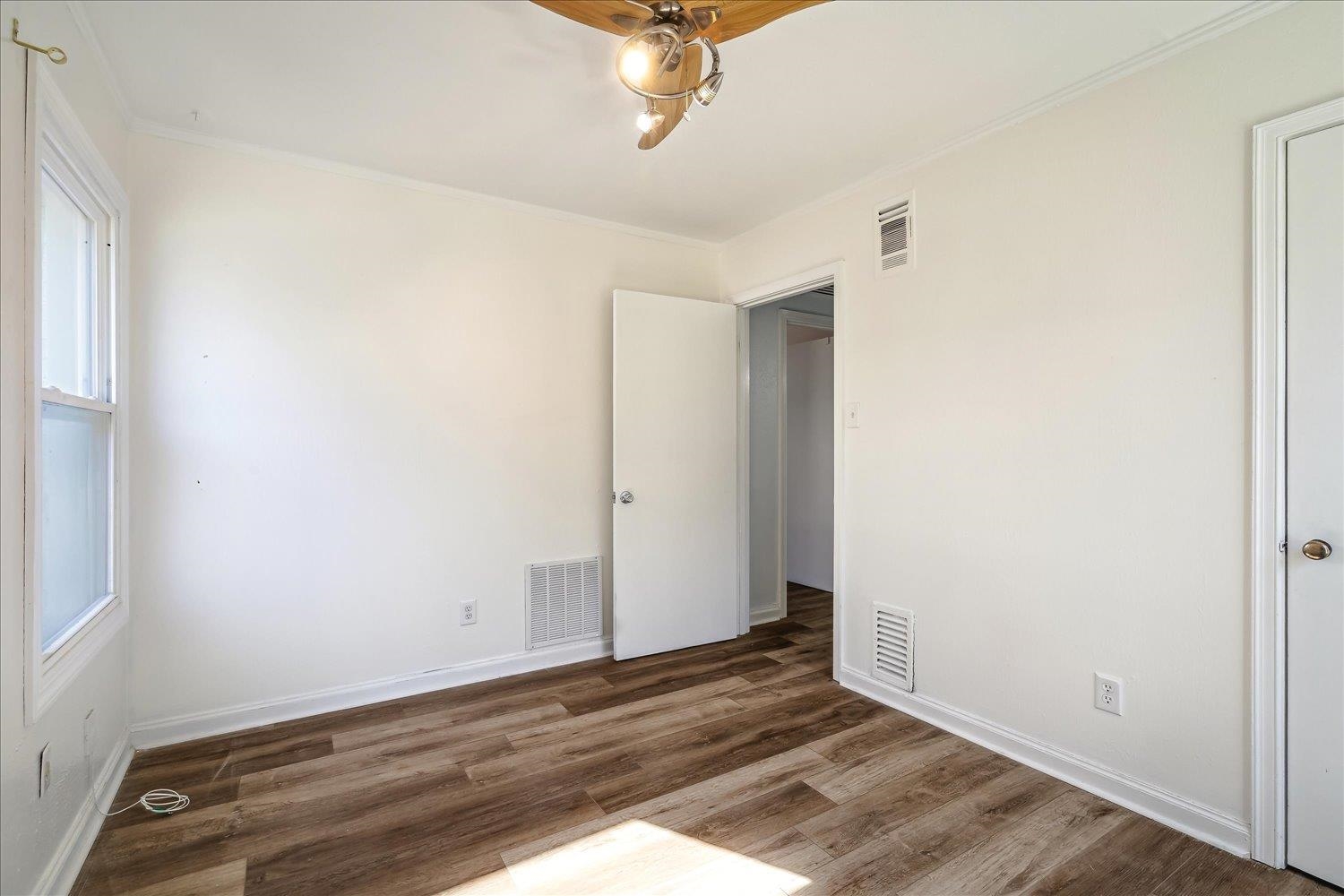 3901 Lytle Circle Memphis, TN 38122 - Photo 17 of 30 Unfurnished bedroom featuring visible vents, multiple windows, and wood finished floors