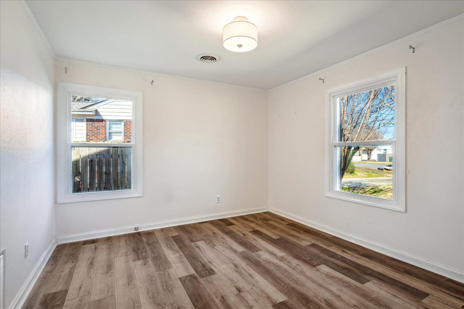 3901 Lytle Circle Memphis, TN 38122 - Photo 18 of 30 Unfurnished room with visible vents, ornamental molding, baseboards, and wood finished floors
