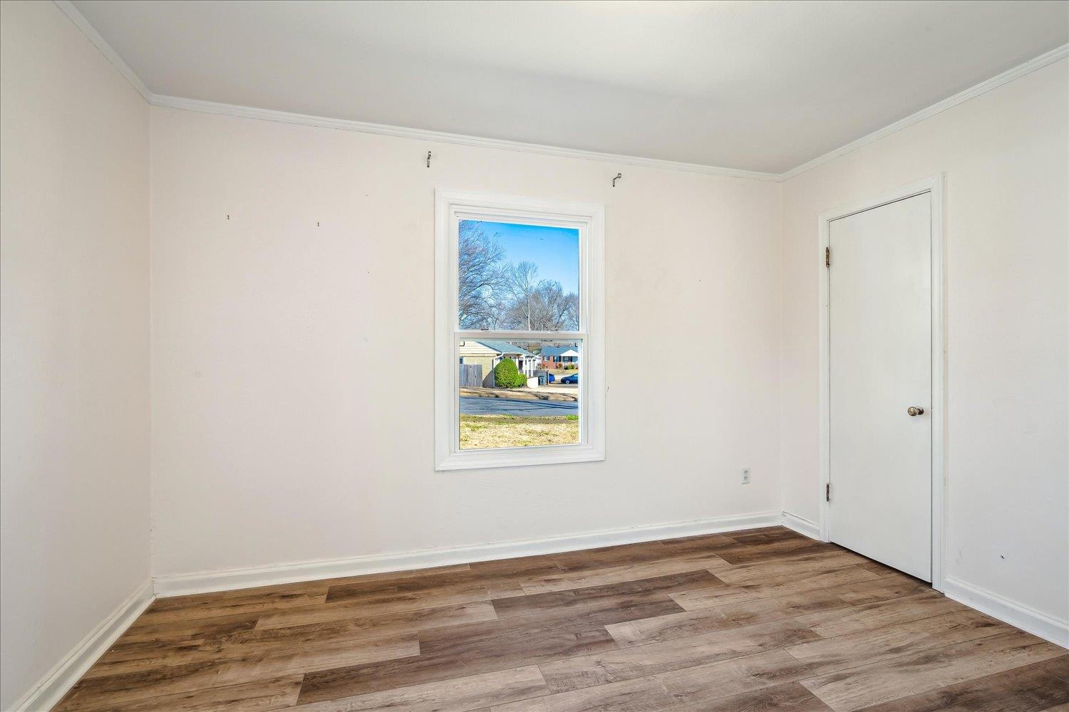 3901 Lytle Circle Memphis, TN 38122 - Photo 19 of 30 Spare room featuring crown molding, baseboards, and wood finished floors
