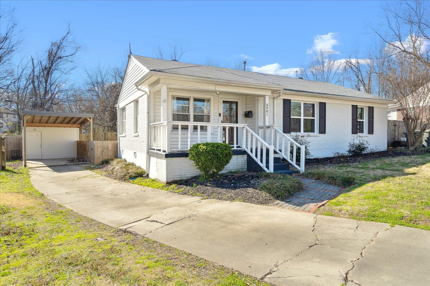 3901 Lytle Circle Memphis, TN 38122 - Photo 2 of 30 View of front of house featuring brick siding, a front lawn, fence, concrete driveway, and covered porch