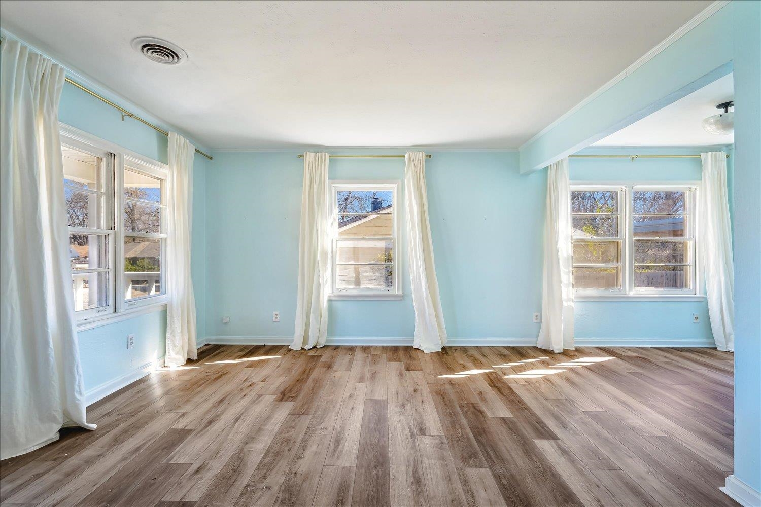3901 Lytle Circle Memphis, TN 38122 - Photo 23 of 30 Empty room with visible vents, baseboards, wood finished floors, and ornamental molding