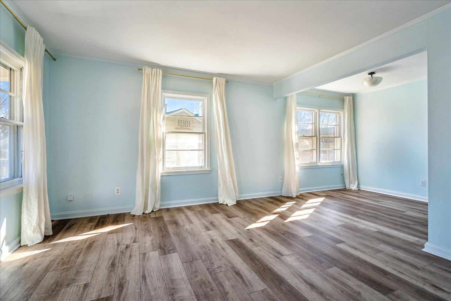 3901 Lytle Circle Memphis, TN 38122 - Photo 6 of 30 Empty room with wood finished floors, baseboards, and ornamental molding