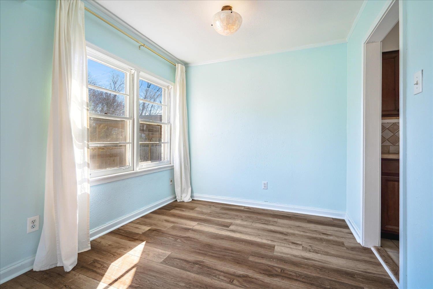3901 Lytle Circle Memphis, TN 38122 - Photo 9 of 30 Unfurnished room featuring crown molding, wood finished floors, and baseboards