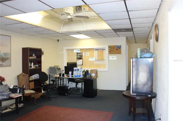 a view of a livingroom with workspace and a window