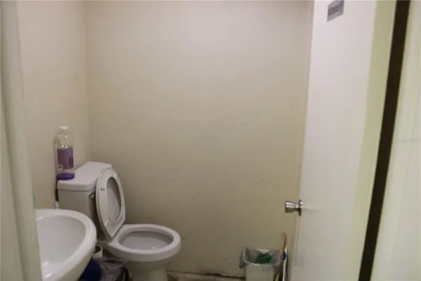 a white toilet sitting next to a sink