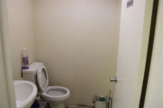 a white toilet sitting next to a sink