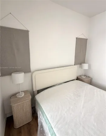 a bedroom with a bed and a chair