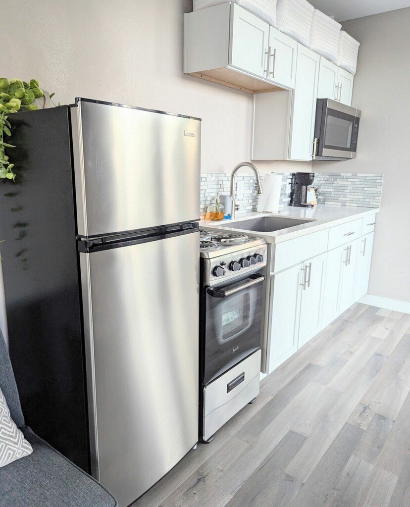 758 Jones Road New Waverly, TX 77358 - Photo 11 of 34 a white refrigerator freezer sitting inside of a kitchen