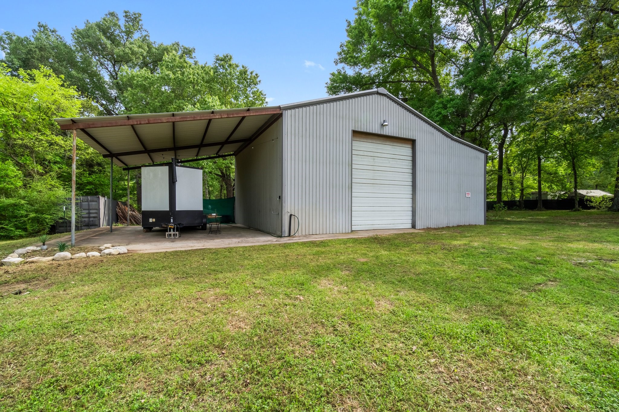 758 Jones Road New Waverly, TX 77358 - Photo 25 of 34 a view of a backyard with a garden and entertaining space