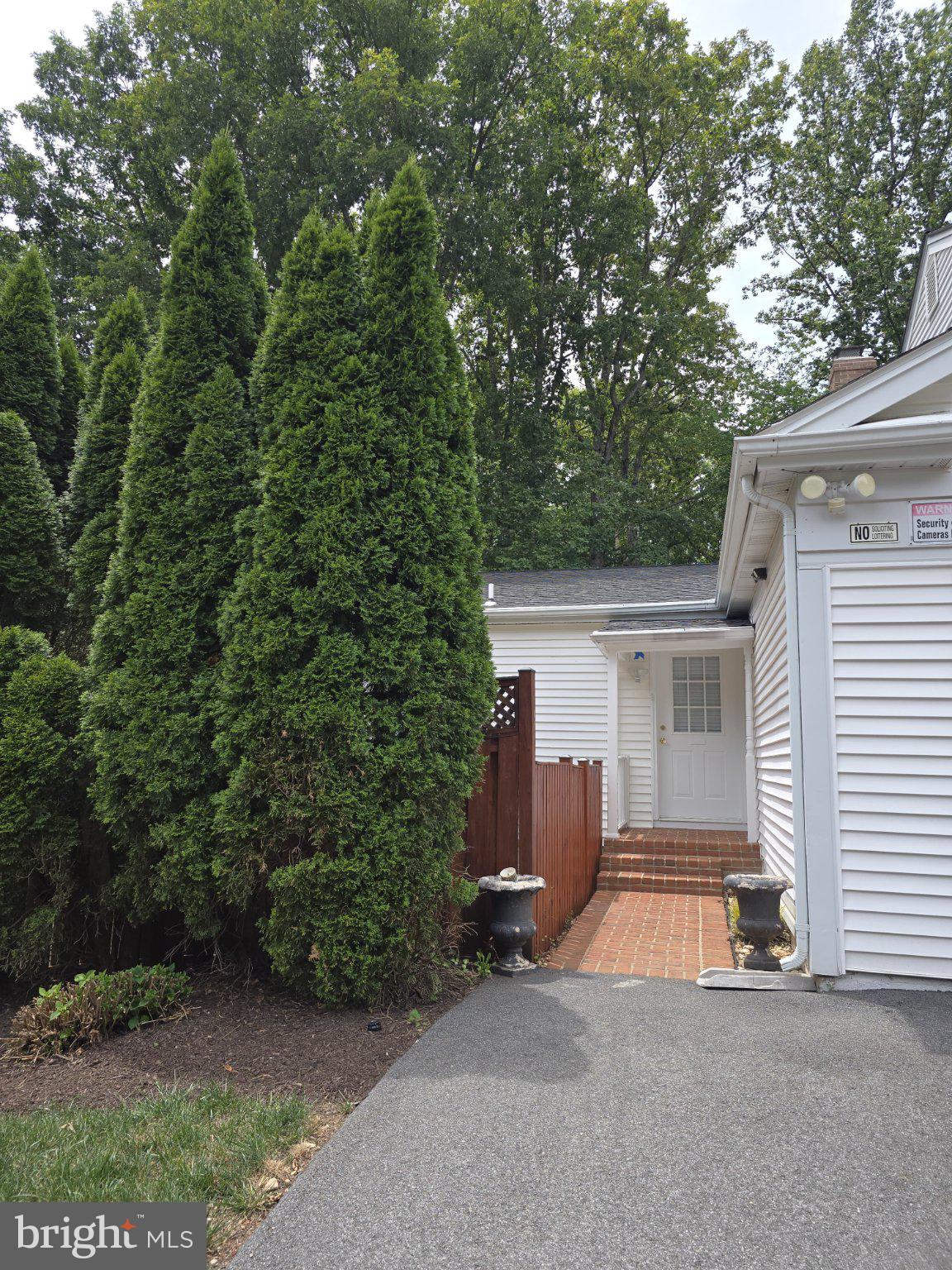 9201 Beachway Lane Springfield, VA 22153 - Photo 5 of 12 Charming entrance with lush greenery.