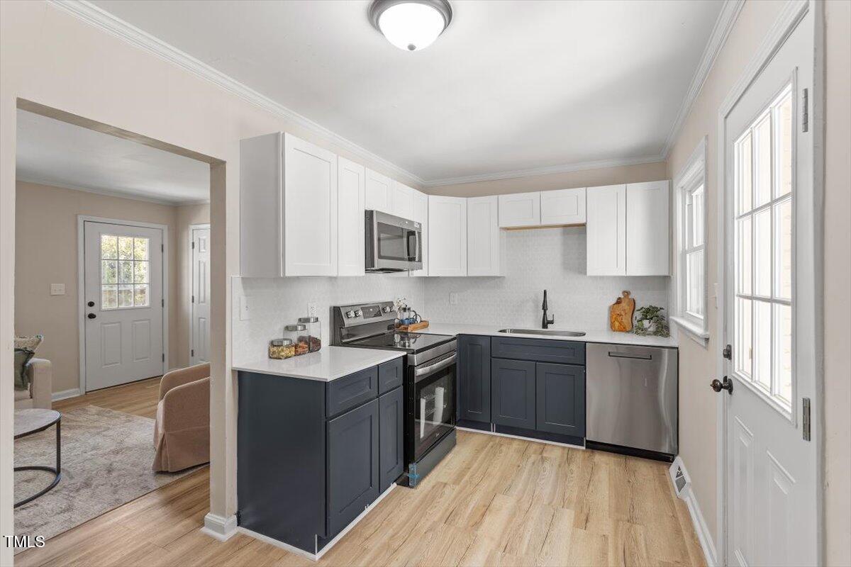 2304 Nelson Street Raleigh, NC 27610 - Photo 3 of 23 a kitchen with granite countertop cabinets stainless steel appliances a sink and a window